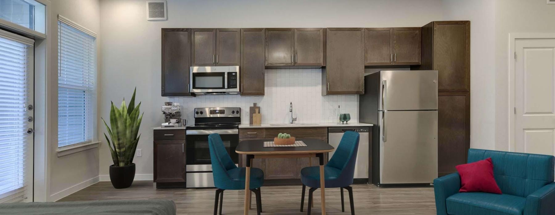 a kitchen with a table and chairs